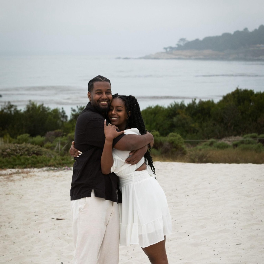 Abigail and Daniel embracing on the beach